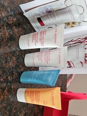 Clarins Hand & Body Creams in White, Blue, Orange, Red Accents Clarins Shampoo